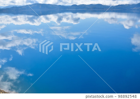 Akita Lake Tazawa with blue sky and water mirror Akita Lake Tazawa with blue sky and water mirror 98892548