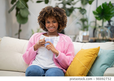 Young black woman enjoying fresh aromatic coffee at home 98892732