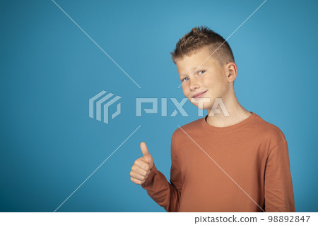 Portrait Of Smiling Preteen Boy Showing Thumb Up At Camera 98892847