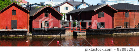 Red harbor warehouses with nice reflections on porvoo river. fishing village in scandinavian style 98893292