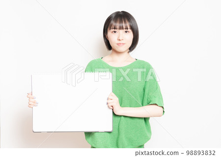Young woman showing a big sketchbook 98893832