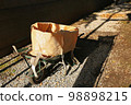 A unicycle designed to clean fallen leaves (a cat unicycle for work): On the street in the late afternoon sun 98898215