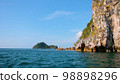 view of the five Tyrrhenian sea coast of Capri, Italy. Rocky cliffs, blue water, floating boats, greenery 98898296
