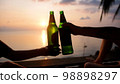 Hands of happy friends cheering celebrating holidays with wine during the epic sunset. Slow Motion. 98898297