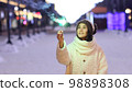 Portrait of young smiling Caucasian woman holding sparklers. Happy cheerful girl outdoors Celebrating New Year holidays vacation. Xmas Christmas winter atmosphere. 3840x2160 98898308