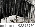 Icicles growing from the roof 98898550