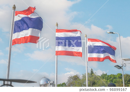 thailand flag. Image of waving three Thai flags of Thailand with blue sky background. thailand flag. Image of waving three Thai flags of Thailand with blue sky background. 98899167