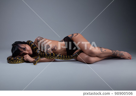 Image of the topless woman in the panties lying on the floor with anaconda Image of the topless woman in the panties lying on the floor with anaconda 98900506