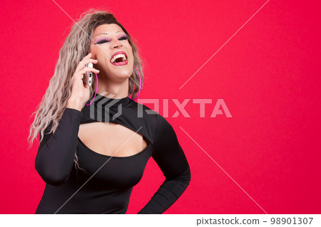 Happy transgender person laughing while talking to the mobile 98901307