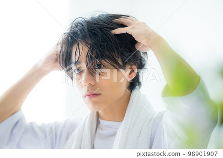 A man in his twenties in a white T-shirt A man in his twenties in a white T-shirt 98901907
