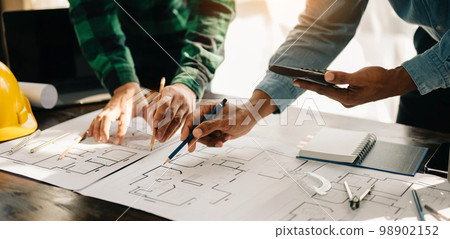 Engineer teams meeting working together wear worker helmets hardhat on construction site in modern city.Asian industry professional team. 98902152