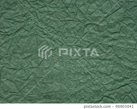 Dark matte green crumpled paper texture. Background for handcrafts, Saint Patrick's Day, new year designs decoration, text, lettering, wall screen saver. Vintage material or page for decoration art. 98903841