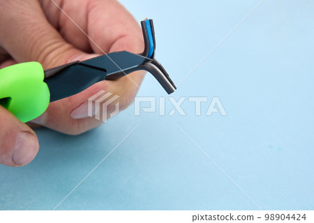 Wire stripping with snap off blade utility knife. Wire stripping with snap off blade utility knife. 98904424