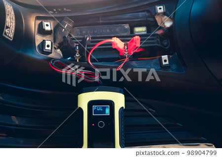 Charging battery in motorcycle for start. Charging battery in motorcycle for start. 98904799