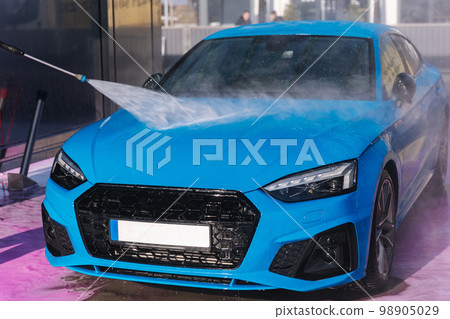 Worker cleaning car using high pressure water. Self servise car washing. Clean auto Worker cleaning car using high pressure water. Self servise car washing. Clean auto 98905029