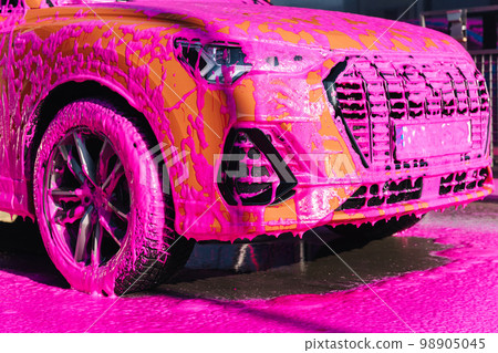Luxury orange car on self servise car washing. Pink foam on auto 98905045