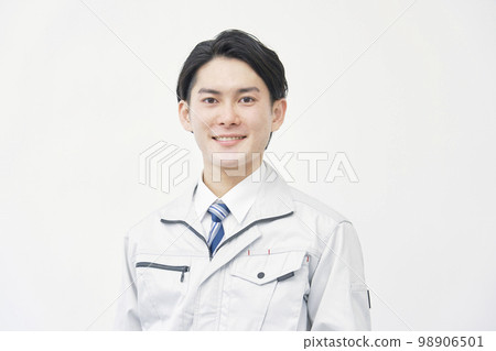 Portrait of a man in work clothes looking at the camera White background 98906501