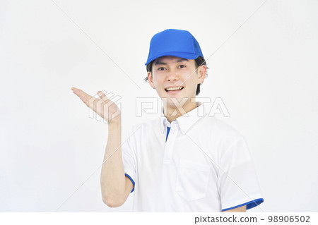 A man in a polo shirt and cap uniform pointing to the left with his palm (movers, transportation companies, workers, courier companies) A man in a polo shirt and cap uniform pointing to the left with his palm (movers, transportation companies, workers, courier companies) 98906502