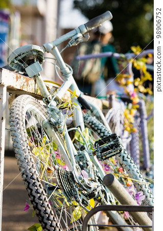 A mountain bike leaning against an iron fence in Kingston, a suburb of London 98906752