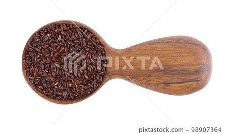 Psyllium seeds in wooden spoon, isolated on white background. Plantain. Plantago psyllium. Top view. 98907364