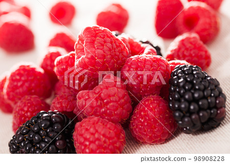 handful of fresh raspberry and blackberry berries on white background 98908228