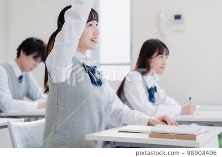 High school girl raising her hand in class 98908406