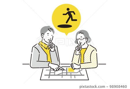 A senior couple who checks the evacuation route with a person hazard map 98908460