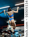 Woman athlete doing pull ups 98909334