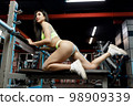 beautiful woman in the gym on the bench for bench press 98909339
