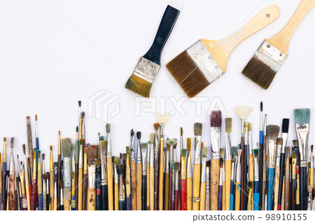 Many brushes for painting on a white background, top view. Many brushes for painting on a white background, top view. 98910155
