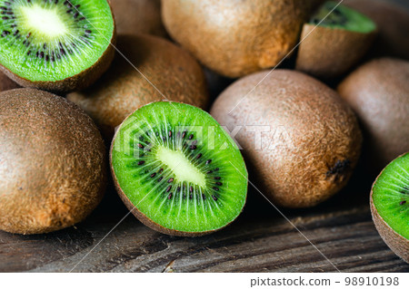 Ripe fruits of kiwi cut and whole, close -up. Ripe fruits of kiwi cut and whole, close -up. 98910198