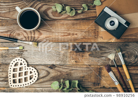 Vintage background with retro camera and paintbrushes, flat lay. 98910256