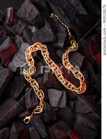 Golden chains earrings on black background. 98910676