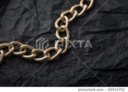 Golden chains earrings on black background. 98910702