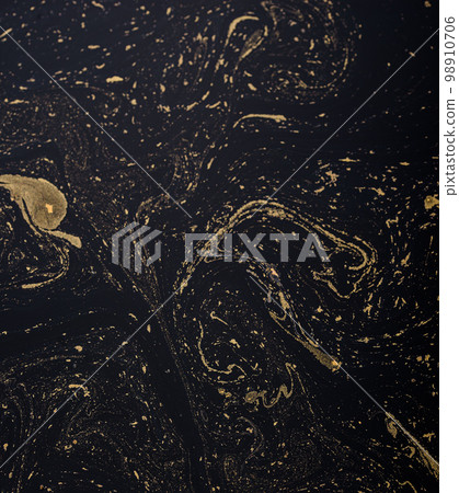 Abstract background with gold and black paint streaks 98910706