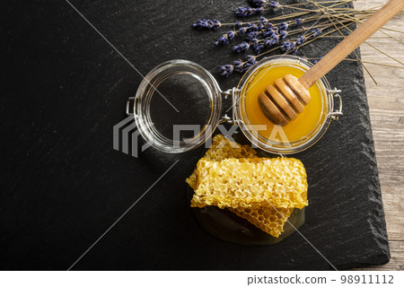 Honeycomb on slate tray on kitchen table closeup 98911112