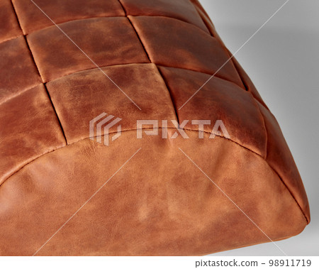 Hand-stitched semi-cylindrical footstool from patches of terracotta leather 98911719