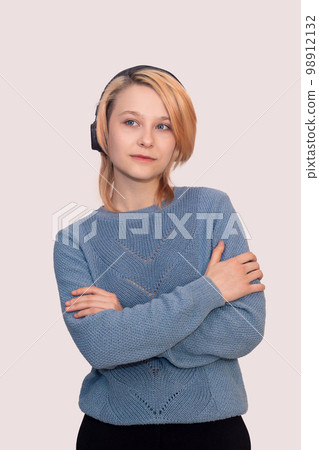 girl teenager with headphones isolated on a light background girl teenager with headphones isolated on a light background 98912132