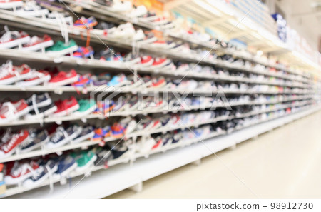 Abstract blur sport shoes on shelves in sneakers shop store background 98912730