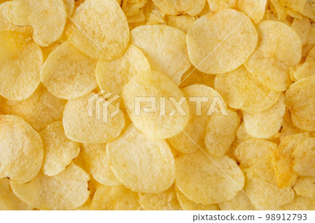 crispy potato chips snack texture background top view 98912793