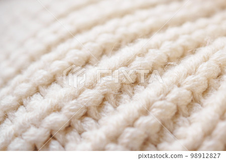 closeup beige knitted woolen fabric texture background 98912827