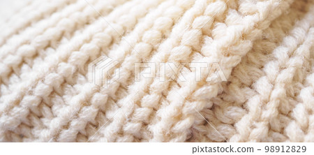 closeup beige knitted woolen fabric texture background 98912829