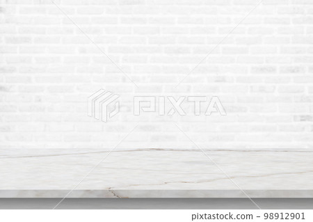 Empty white marble table top with brick wall background 98912901