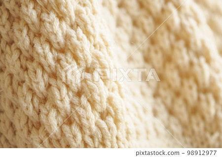 closeup beige knitted woolen fabric texture background closeup beige knitted woolen fabric texture background 98912977