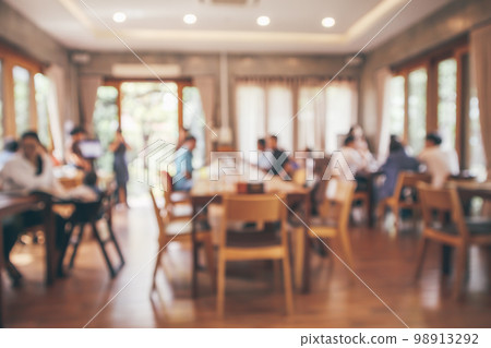 Restaurant interior with customer and wood table blur abstract background with bokeh light 98913292