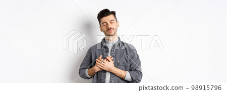 Nostalgic man hold hands on heart, remember tender memories, standing on white background 98915796