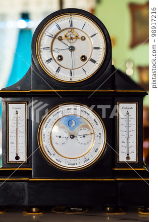 Vintage table clock with white deal and retrograde calendar 98917216