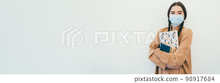 Young female student in a protective mask Young female student in a protective mask 98917684