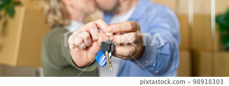 Couple showing keys to new apartment. real estate mortgage, loan concept. moving in new house Couple showing keys to new apartment. real estate mortgage, loan concept. moving in new house 98918303