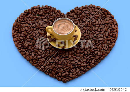 Ceramic coffee cup with coffee beans for americano, espresso, latte on blue 98919942